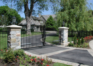 swing gate in masonry columns with custom scrollwork