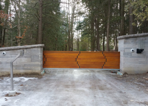 Modern wood slide gate in masonry columns