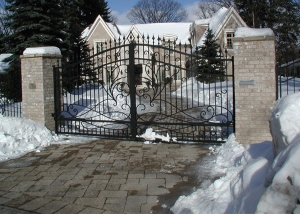 Swing Gate with scrollwork and masonry columns